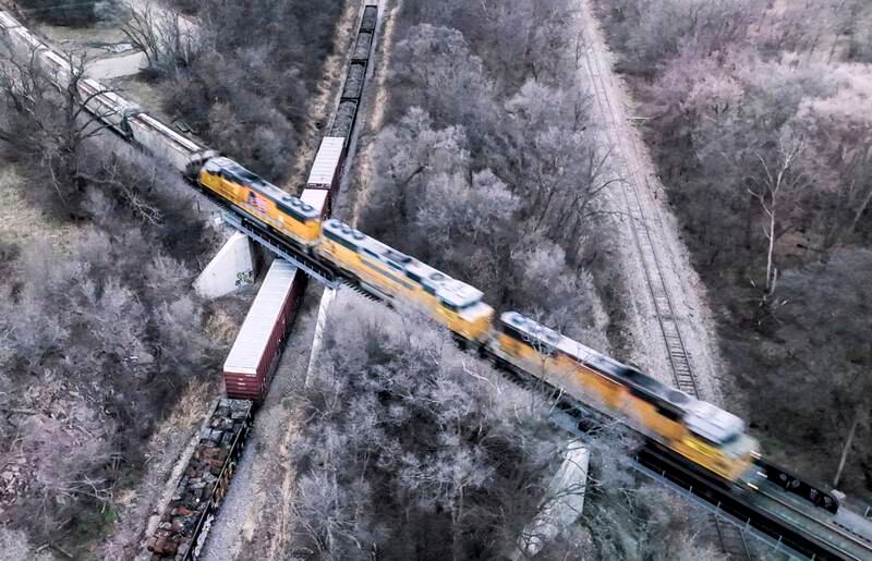 A freight train passes over parked rail cars in Janesville, Wisconsin, USA. EPA