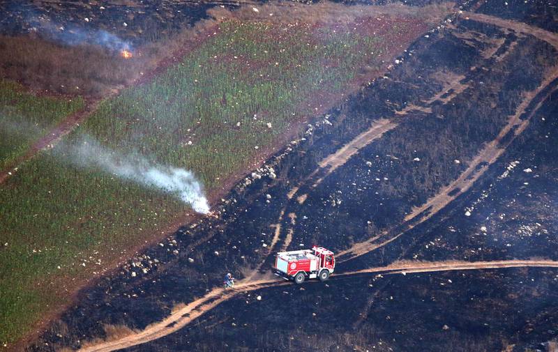 A firefighter truck is seen as smoke rises from shells fired from Israel in Maroun Al-Ras village, near the border with Israel, in southern Lebanon, September 1, 2019. REUTERS/Ali Hashisho