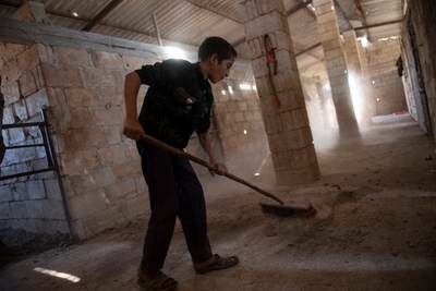 Cleaning the stables is a daily chore in Berri Al-Sharqi