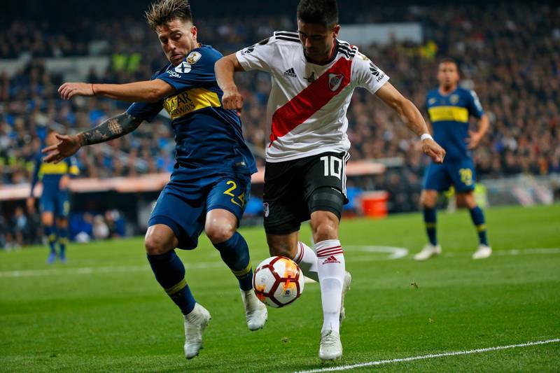 Gonzalo Martinez of River Plate, right, holds off Julio Buffarini of Boca Juniors during extra time. AP Photo/Andrea Comas