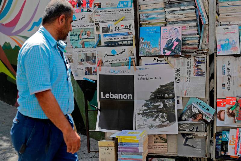 A man looks at the front pages of the Lebanese local English-language newspaper "The Daily Star" in the capital Beirut on August 8, 2019, which refrained from publishing news articles in its print edition today in protest against the "deteriorating situation" in Lebanon. A special edition was printed with each page listing one main issue dragging the country toward the abyss. Despite the worsening political, economic, financial and social problems, there is still time to save the country, the Daily Star, which was first established in the 1950s, announced.  / AFP / JOSEPH EID
