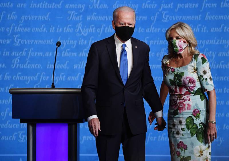 Democratic presidential candidate Joe Biden, left, and wife Jill Biden wear protective masks on stage. Bloomberg