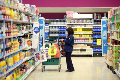 An employee selects items of shopping for home delivery at the Tesco Basildon Pitsea Extra supermarket, operated by Tesco Plc, in Basildon, U.K., on Tuesday, Dec. 1, 2015. Many European food retailers are coming to terms with persistently low inflation as well as consumers who remain frugal yet purchase food more frequently. Photographer: Chris Ratcliffe/Bloomberg