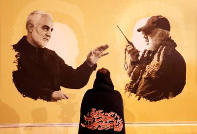A person looks at a banner displayed at a commemoration ceremony at Iraq's Baghdad airport on January 2, 2020 to mark the first anniversary of the killing of senior Iranian military commander General Qassem Suleimani and Iraqi militia commander Abu Mahdi Al Muhandis in a US drone strike. Reuters
