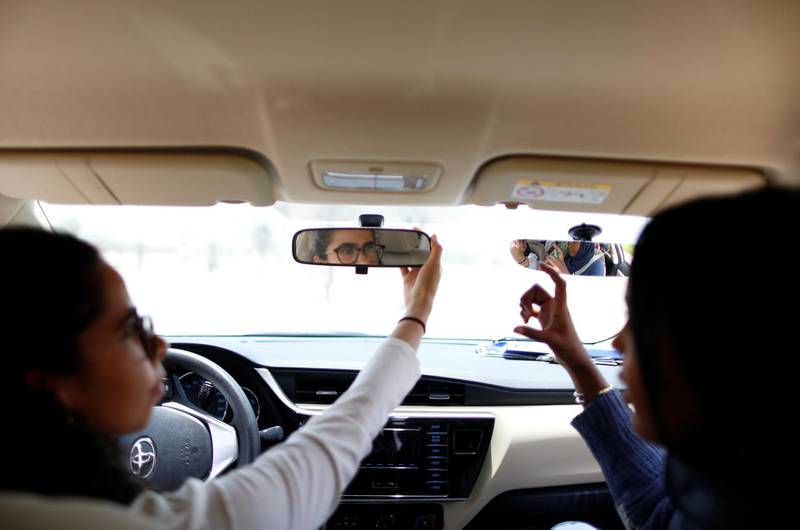 Maria Al Faraj, left, adjusts her rear-view mirror. Ahmed Jadallah / Reuters