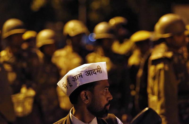 An APP supporter stands in front of Indian policemen during a protest outside the BJP headquarters in New Delhi on March 5, 2014. Street clashes marred an announcement on Wednesday that India's general election will start on April 7. Anindito Mukherjee / Reuters