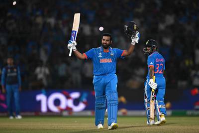 India's captain Rohit Sharma celebrates after scoring his century against Afghanistan in the Cricket World Cup match at the Arun Jaitley Stadium in New Delhi on October 11, 2023. AFP