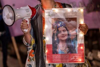 A demonstrator holds a picture of Mahsa Amini during a protest march on Friday night in Berlin, Germany. Getty Images