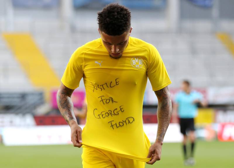 Soccer Football - Bundesliga - SC Paderborn v Borussia Dortmund - Benteler Arena, Paderborn, Germany - May 31, 2020 Borussia Dortmund's Jadon Sancho celebrates scoring their second goal with a 'Justice for George Floyd' shirt, as play resumes behind closed doors following the outbreak of the coronavirus disease (COVID-19) Lars Baron/Pool via REUTERS   DFL regulations prohibit any use of photographs as image sequences and/or quasi-video     TPX IMAGES OF THE DAY