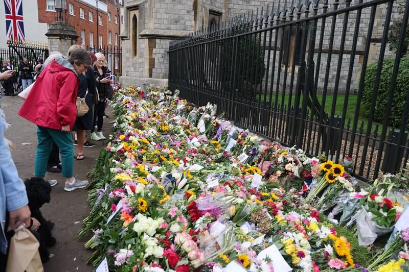 Members of the public leave flowers and tributes at The Long Walk gates in front of Windsor Castle in Windsor, England. Getty
