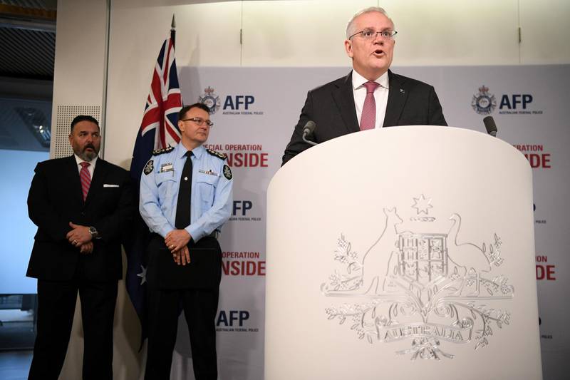 In Sydney, Australian Prime Minister Scott Morrison briefs the media about Operation Ironside, which disrupted organised crime internationally, as the US embassy's FBI legal attache Anthony Russo, left, and Australian Federal Police Commissioner Reece Kershaw, centre, look on. Reuters