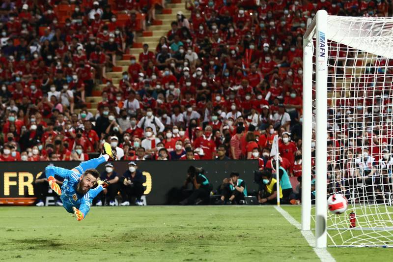 Manchester United goalkeeper David de Gea dives to try to save a shot. AFP