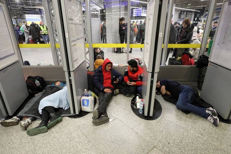 Ukrainian refugees rest at Warsaw East train station in Poland. EPA