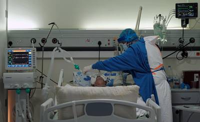 A medical worker assists a patient suffering from coronavirus, in an intensive care unit at Rafik Hariri University Hospital, in Beirut, Lebanon. Reuters