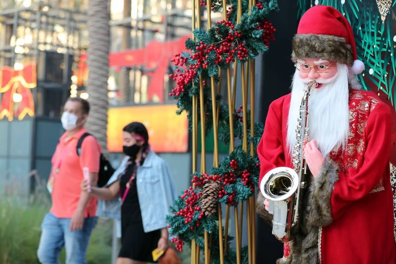 A couple walk pasted a santa statue at Expo 2020 in Dubai. Chris Whiteoak/ The National