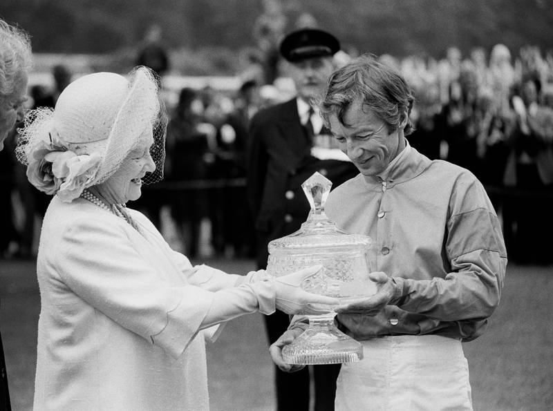 Lester Piggott receiving the Ritz Club trophy from the Queen Mother in 1981. PA