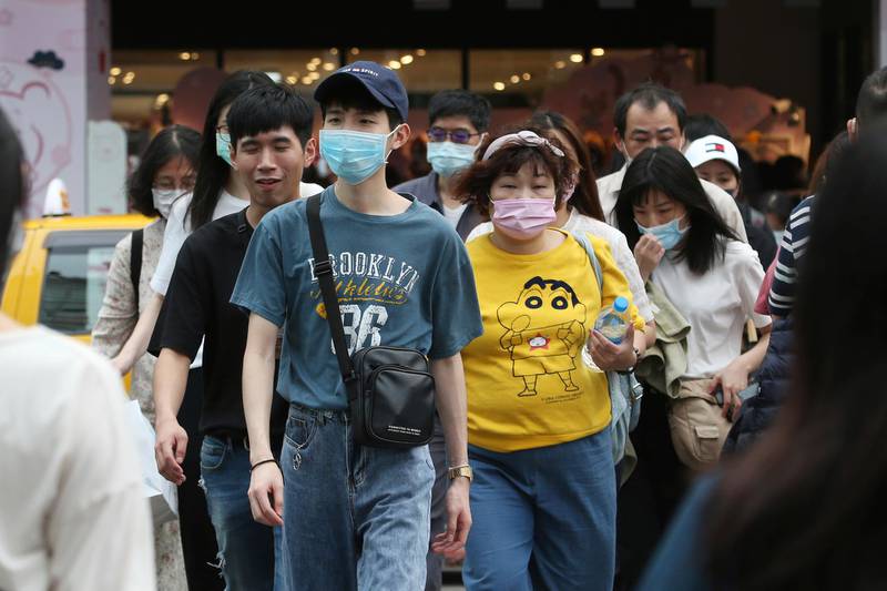 Taiwanese people wear face masks to protect against the spread of the coronavirus in Taipei. AP