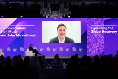 Mr Musk speaks by video in June to the Qatar Economic Forum in Doha. Bloomberg