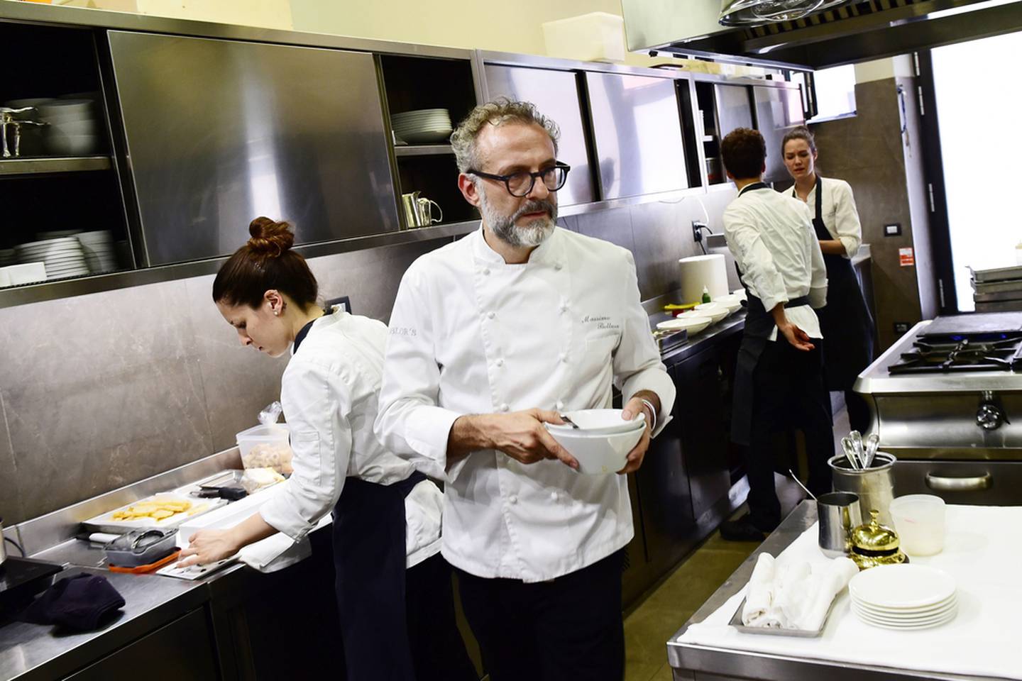Italian chef Massimo Bottura working in the kitchen of his restaurant Osteria Francescana in Modena. AFP