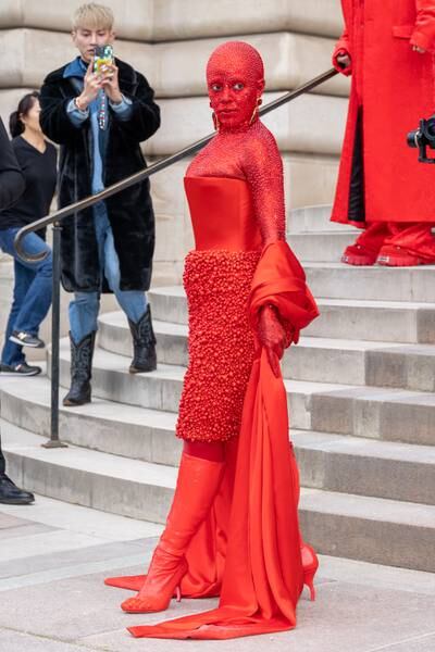 Doja Cat attends the Schiaparelli haute couture spring/summer 2023 show covered head to toe in red crystals. Getty Images