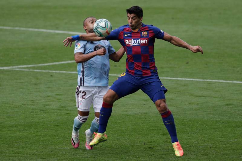 Barcelona's Luis Suarez shields the ball from Rafinha of Celta Vigo. AP