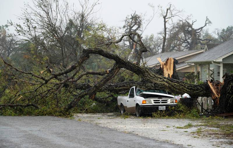 A car is crushed by a huge tree after Hurricane Harvey struck in Rockport, Texas.Rick Wilking / Reuters