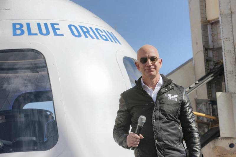Jeff Bezos, chief executive officer of Amazon.com Inc. and founder of Blue Origin LLC, smiles while speaking at the unveiling of the Blue Origin New Shepard system during the Space Symposium in Colorado Springs, Colorado, U.S., on Wednesday, April 5, 2017. Bezos has been reinvesting money he made at Amazon since he started his space exploration company more than a decade ago, and has plans to launch paying tourists into space within two years. Photographer: Matthew Staver/Bloomberg