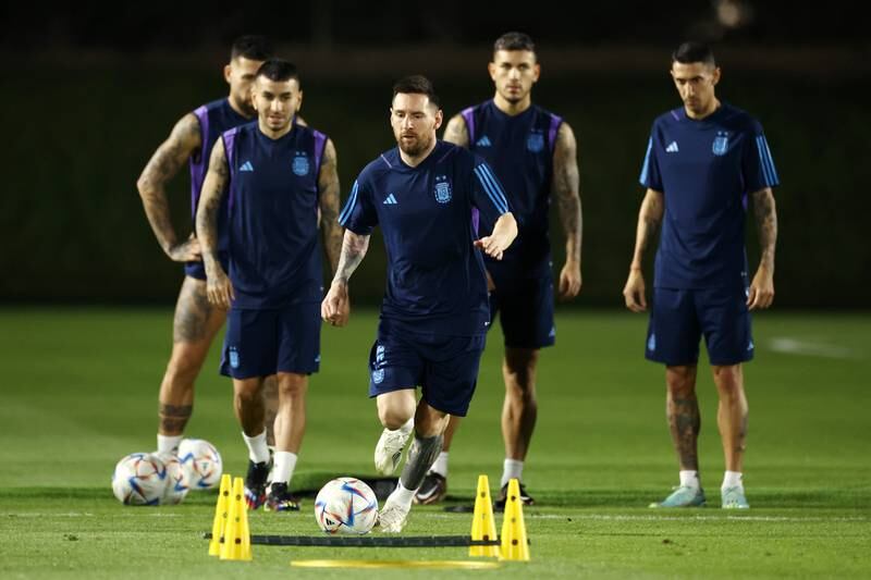 Lionel Messi runs with the ball at Aspire Training Ground. Getty