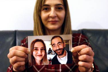 Aya Al Umari holds a photo of herself and her brother Hussein, who was killed in the Christchurch mosque attacks in March 2019. AP
