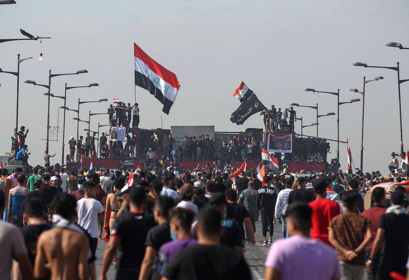 Iraqi demonstrators gather on Al-Jumhuriya Bridge in the capital Baghdad  to mark the first anniversary of a massive anti-government movement demanding the ouster of the entire ruling class accused of corruption.  AFP