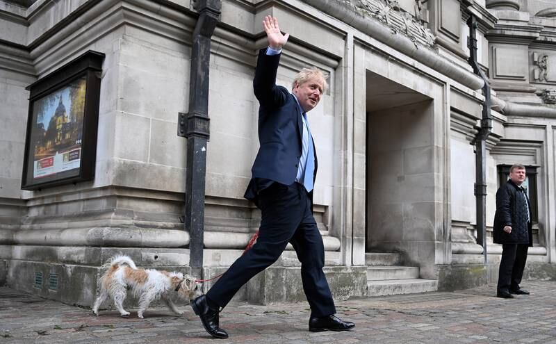 British Prime Minister Boris Johnson exits a polling station with his dog Dilyn after voting in the local elections in Westminster, London. EPA