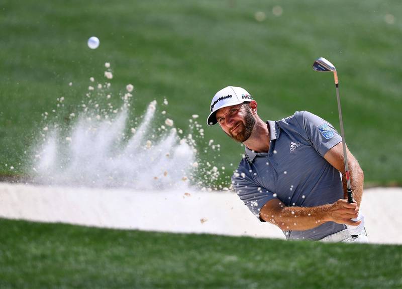 Dustin Johnson blasts from a bunker to the 18th green during a practice round for the Masters golf tournament at Augusta National Golf Club in Augusta, Ga., Tuesday, April 3, 2018. (Curtis Compton/Atlanta Journal-Constitution via AP)