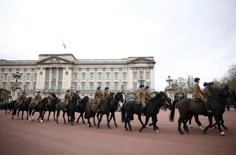 Members of the Household Cavalry ride past Buckingham Palace, London. Reuters