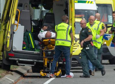 A man wounded in the mosque attack in Christchurch is loaded in an ambulance.