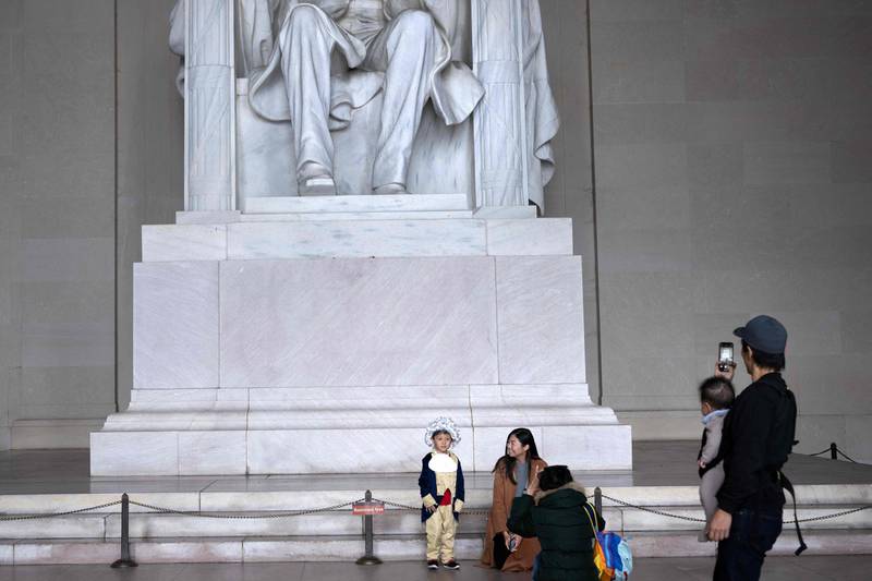 A boy dressed as a revolutionary visits the Lincoln Memorial with others during Halloween in Washington. AFP