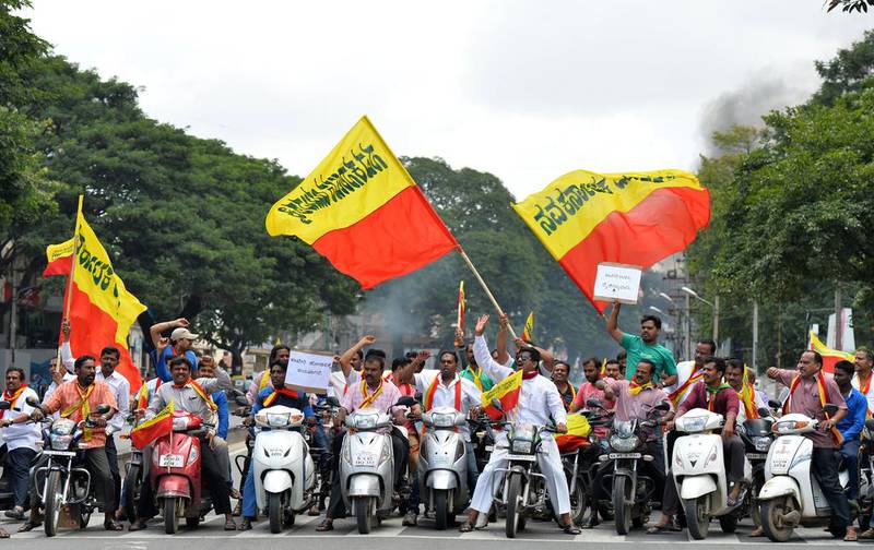 File: Pro-Karnataka activists wave the Karnataka flag during a motorcycle rally on September 9, 2016, as part of a statewide strike in Bangalore, India. Agitation in the southern Indian state of Karnataka has been increasing since a recent Supreme Court order to release water from the River Cauvery each day to the neighbouring state of Tamil Nadu.  Agence France-Presse