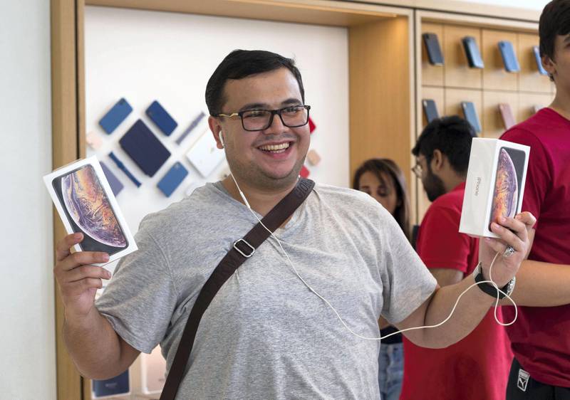 DUBAI, UNITED ARAB EMIRATES, 21 SEPTEMBETR 2018 - An iPhone fan purchasing 2 phones at the launch of iPhone XS at Apple store, Dubai Mall.  Leslie Pableo for The National for Alkesh Sharma’s story