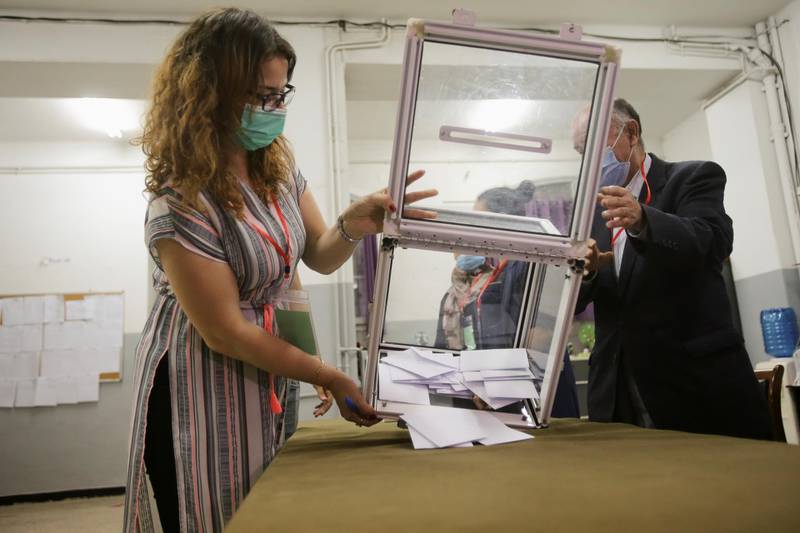 Election workers empty a ballot box at the end of voting in the parliamentary election in Algiers. Reuters