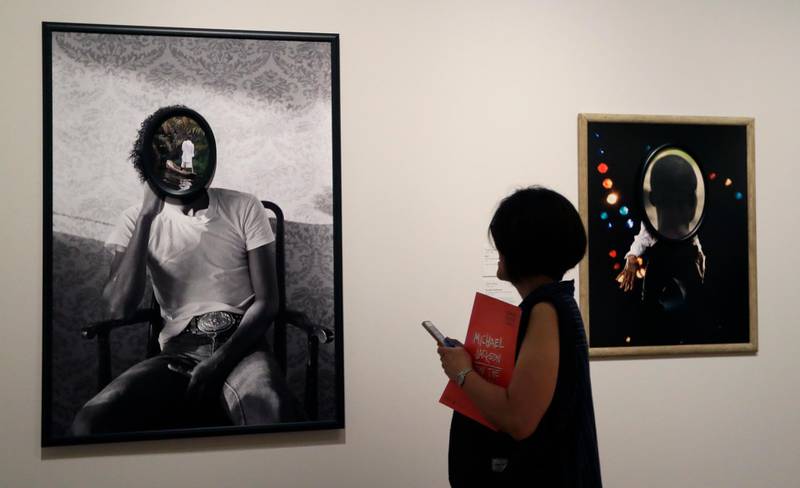 A woman looks at artworks by Todd Gray on display at the "Michael Jackson: On the Wall" at the National Portrait Gallery in London, Britain, on June 27, 2018. Kirsty Wigglesworth / AP Photo