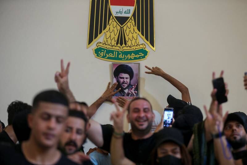 Mr Al Sadr's supporters make their feelings known through gestures inside the palace. Reuters