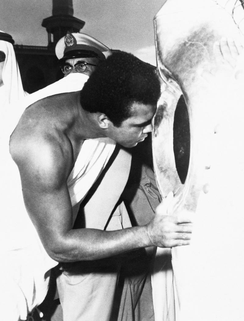 Former world heavyweight boxing champion Muhammad Ali kisses the Black Stone in the Kaaba while performing Hajj in 1972. Getty