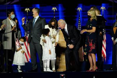 Vice president-elect Kamala Harris and president-elect Joe Biden stand on stage with family members in Wilmington, Delaware. AP Photo
