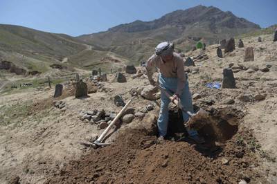 A man digs a grave for one of the 57 victims of a bomb blast before the burial a day after the attack on a voter registration centre in Kabul, on April 23, 2018. Shah Marai / AFP