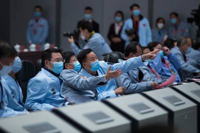 Technical personnel work at the Beijing Aerospace Control Center (BACC) in Beijing. Xinhua via AP