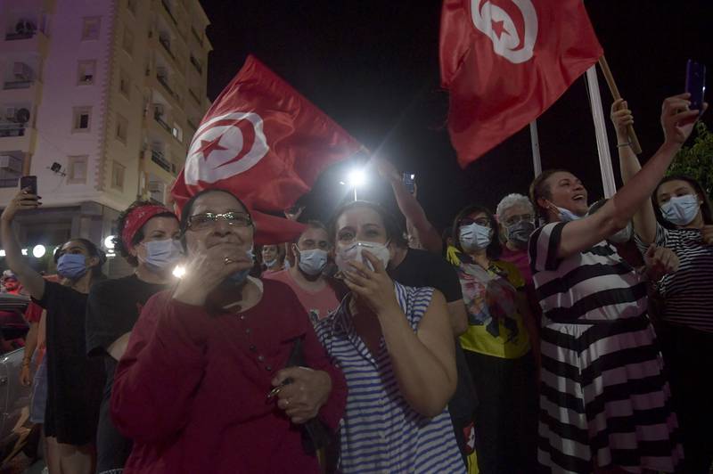 Thousands of Tunisians waved flags and honked horns in cities and towns across the country.