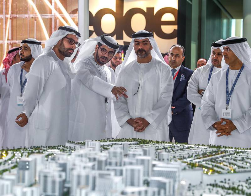 Abu Dhabi, UAE,  April 17, 2018.  CITYSCAPE Abu Dhabi 2018.  H.H. Sheikh Hamed bin Zayed Al Nahyan visits the Aldar stand at Cityscape.  (L-R) HE Mohamed Khalifa Al Mubarak, Chairman of Abu Dhabi Tourism & Culture Authority; Talal Al Dhiyebi, CEO of Aldar Properties; and H.H. Sheikh Hamed bin Zayed Al Nahyan.Victor Besa / The NationalNationalReporter:  Sarah Townsend