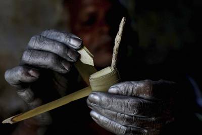 An villager folds palm leaves as he makes firecrackers with his bare hands at his workshop in Bhingharpur village, outskirts of Bhubaneswar.  Biswaranjan Rout / AP Photo