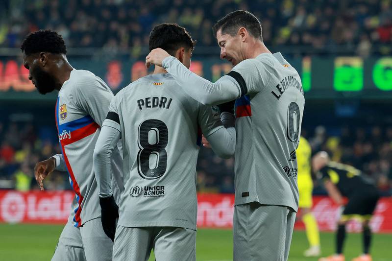 Pedri celebrates with Robert Lewandowski after scoring for Barcelona against Villarreal. AFP