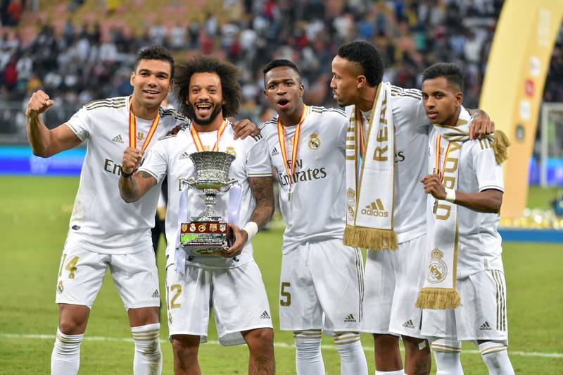 Real Madrid's Brazilian players Casemiro, Marcelo, Vinicius Junior, Eder Militao and Rodrygo pose with the trophy after winning the Spanish Super Cup on January 12, 2020, in the Saudi Arabian port city of Jeddah. AFP