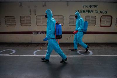 Health workers disinfect a train converted to a Covid-19 care centre after a surge in the number of positive coronavirus cases in Guwahati, India. AP